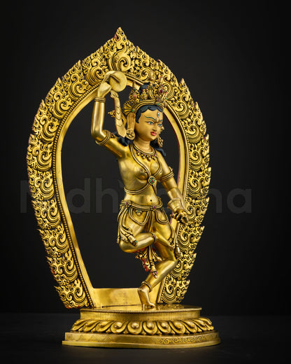 Side view Machig Labdron Himalayan sculpture holding damaru and ritual bell with detailed gold gilded craftsmanship by skilled Newari artisan from Patan Nepal