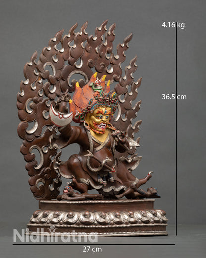 Side view of Mahakala Bernagchen statue lotus pedestal subdued figures sacred Buddhist guardian deity oxidized copper Himalayan craftsmanship