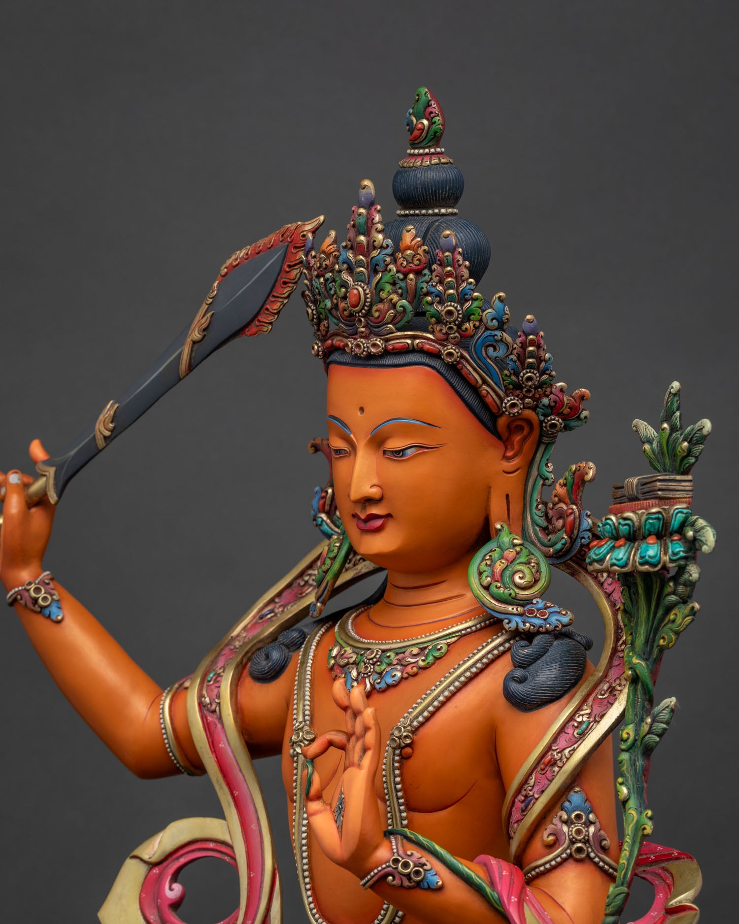 Side view Manjushri copper statue intricate lotus pedestal cloud ribbons Nepali Buddhist sculpture