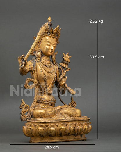 Side view of Manjushri statue holding utpala flower in abhaya mudra, double-edged wisdom sword flame, crown, antique copper Buddhist meditation art, Nepal