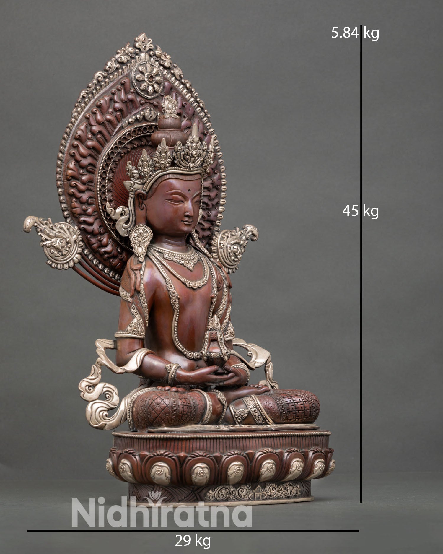 Side view of Nepalese Amitayus Buddha statue with ornate halo and silver plated Buddhist artwork