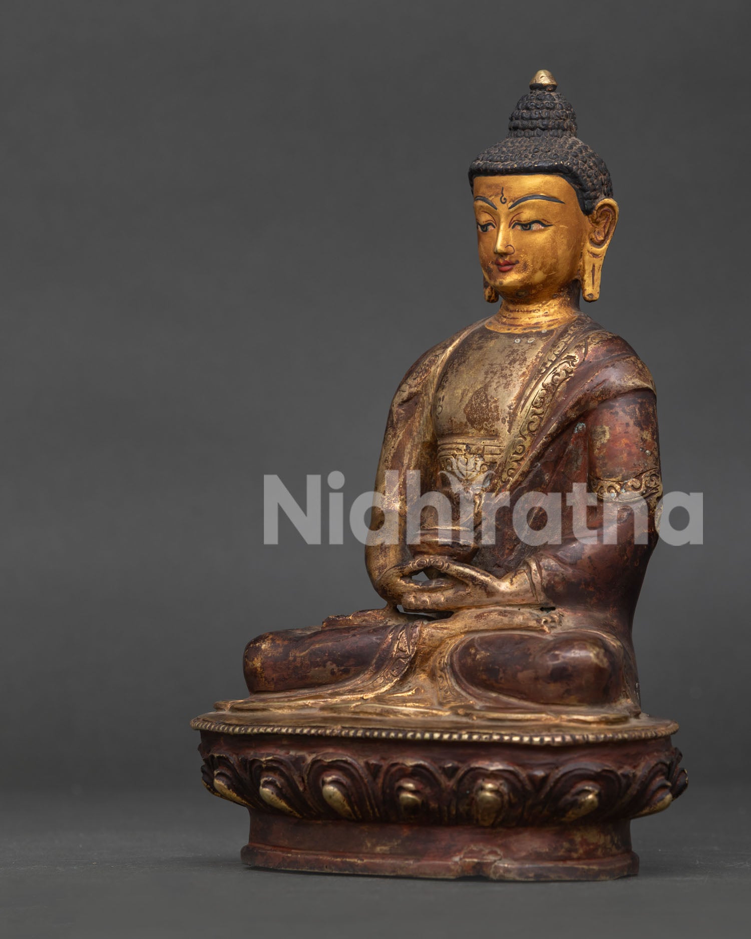 Side view of Amitabha Buddha statue showing handcarved lotus pedestal monk robe and antique oxidized finish.