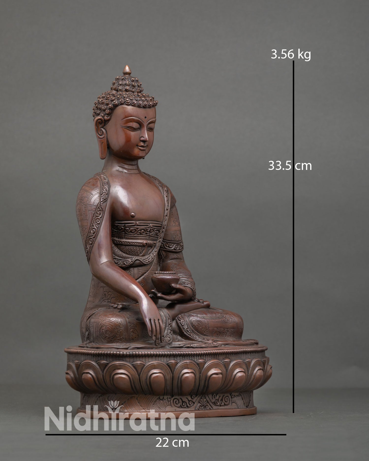 Side view of Buddha Shakyamuni statue seated on lotus base with oxidized copper texture, and traditional Buddhist sacred art design