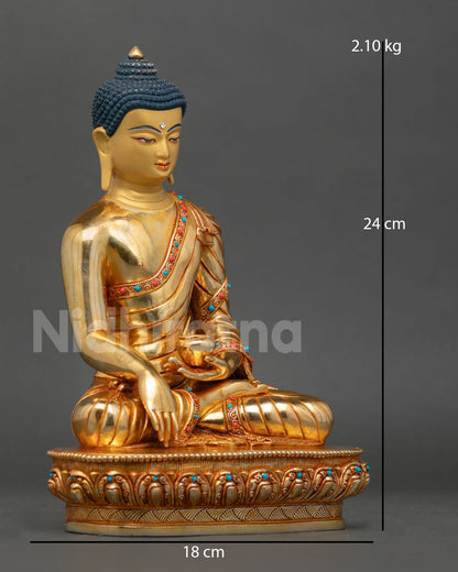 Side view of Buddha Shakyamuni statue seated on a lotus pedestal with earth-touching mudra and a patra bowl