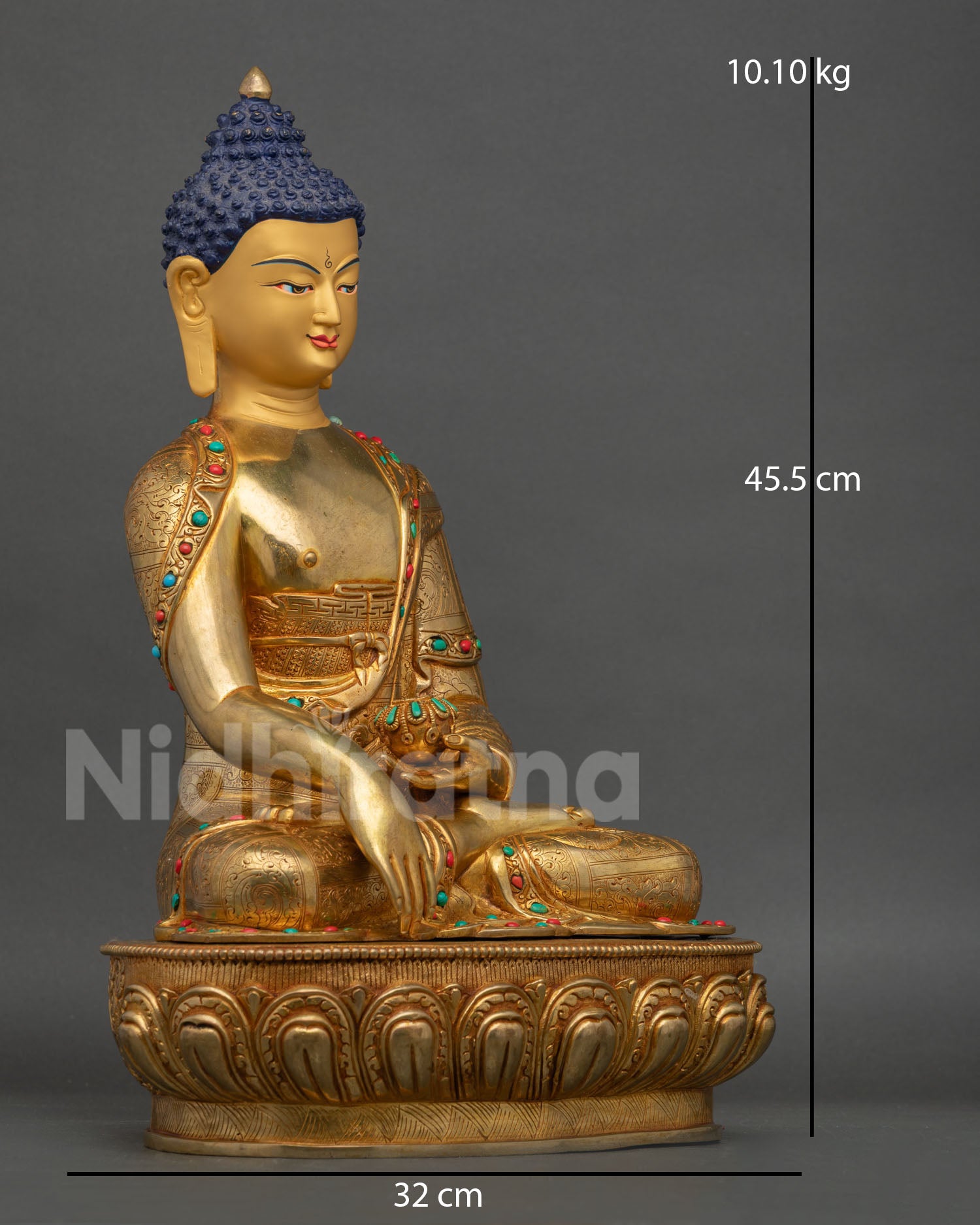 Side view of Buddha statue holding begging bowl with detailed copper robes and stone inlays