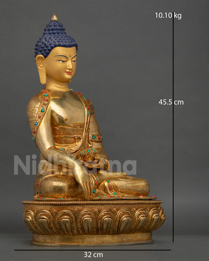 Side view of Buddha statue holding begging bowl with detailed copper robes and stone inlays