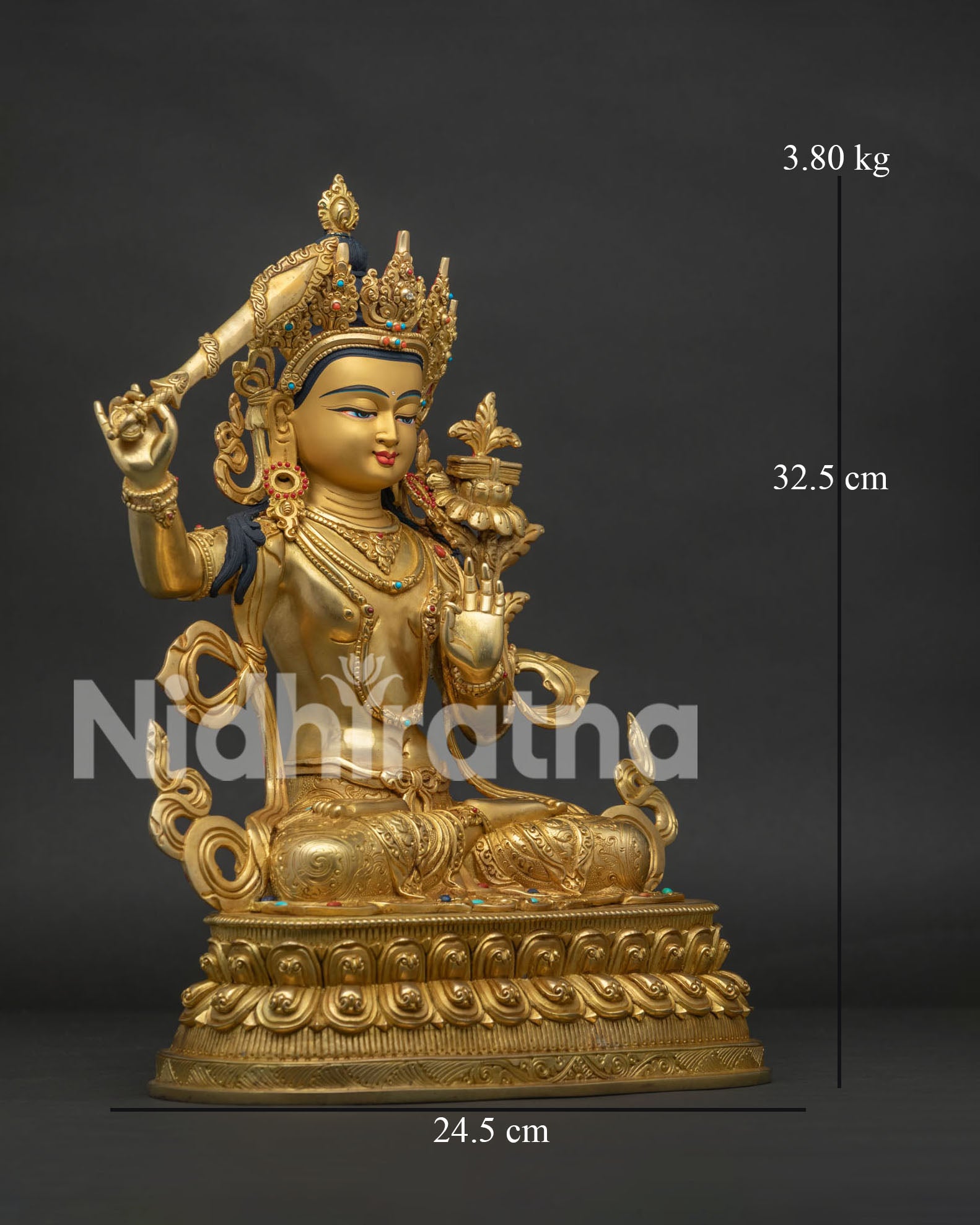 Side view of Buddhist Manjushri Statue holding flaming sword and lotus flower