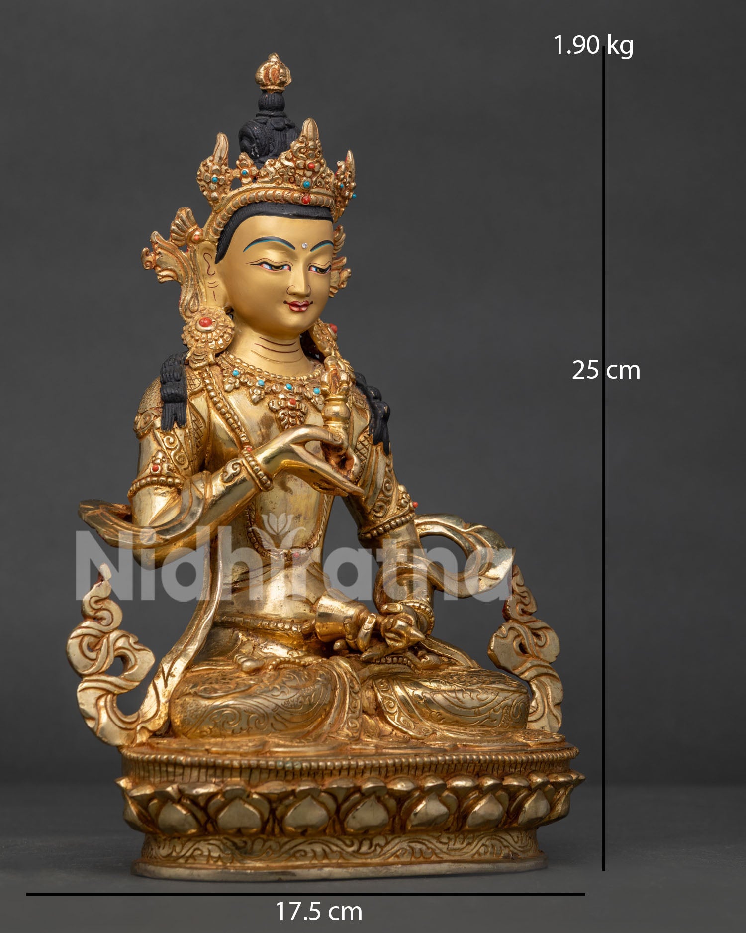 Side view of copper Vajrasattva holding vajra and bell in a seated meditation posture