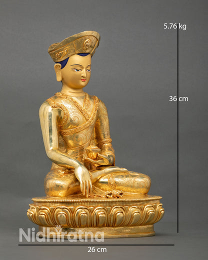 Side view of Drikung Kagyu lineage master Jigten Sumgon statue holding patra with vajra placed on lotus base symbolizing renunciation and wisdom