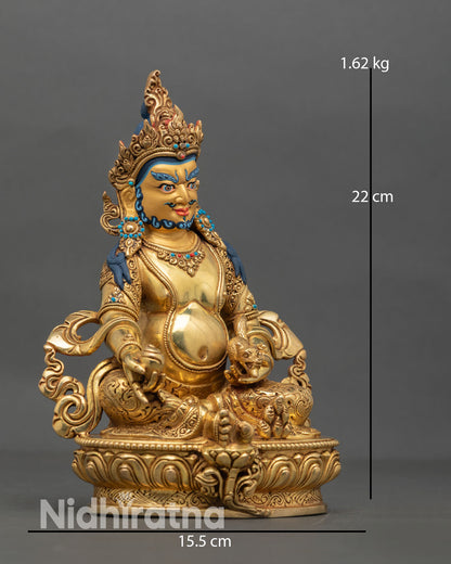 Side view of Dzambhala statue holding mongoose and citron fruit, copper sculpture representing removal of poverty and flow of prosperity energy