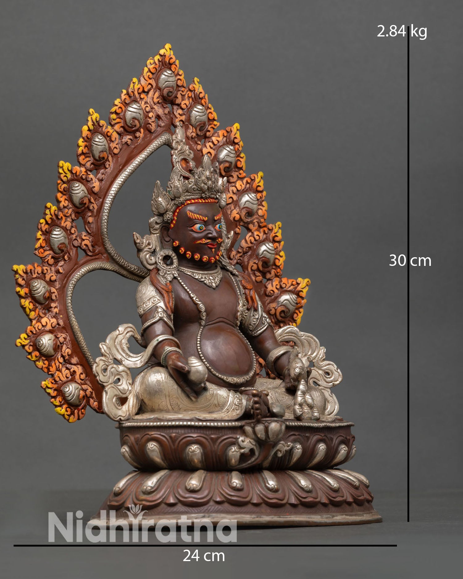Side view of Dzambhala statue with intricate halo and lotus pedestal in silver-plated finish