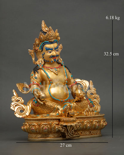 Side view of Dzambhala wealth deity statue holding mongoose and citron fruit in traditional Buddhist symbolism