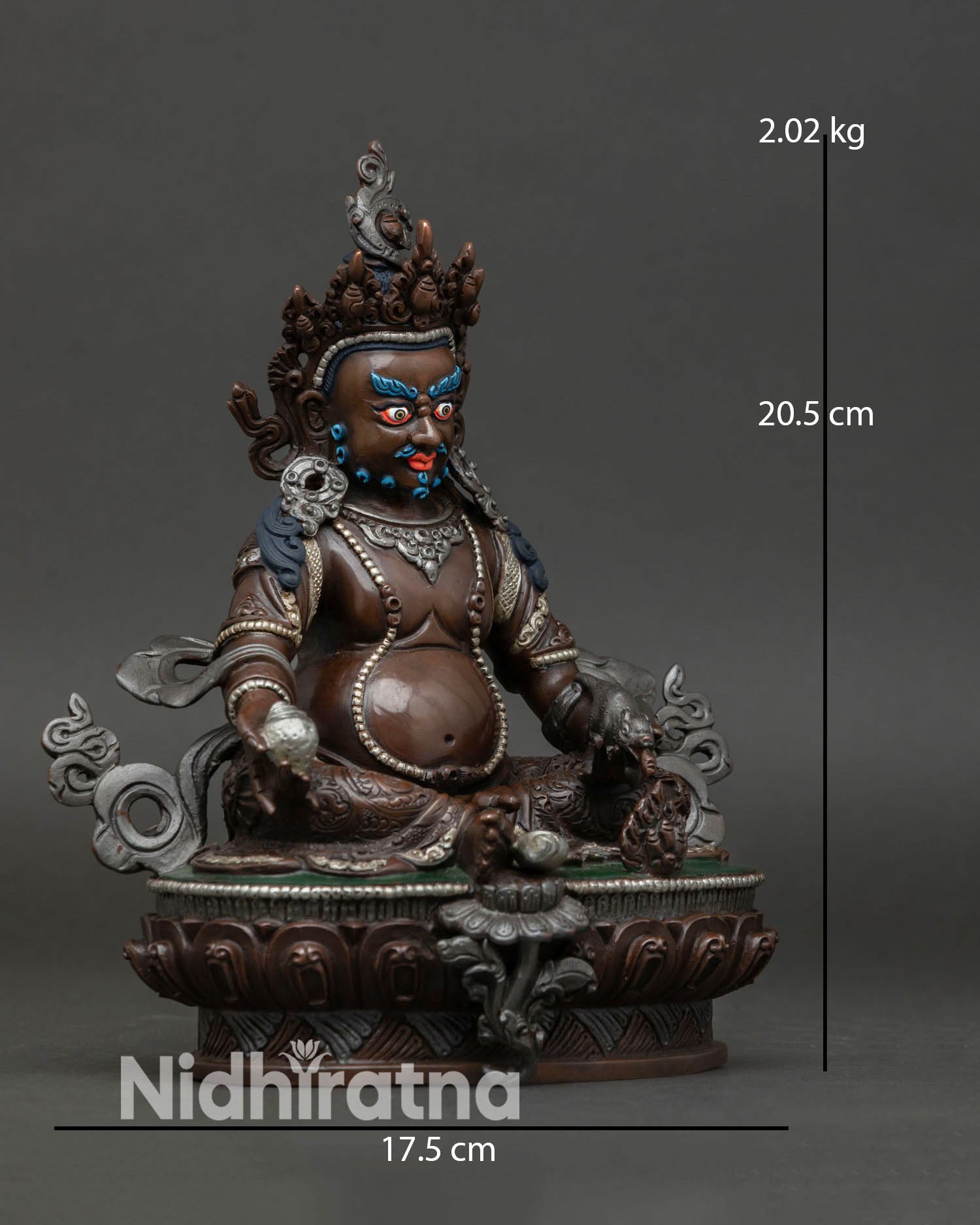 Side view of Dzambhala wealth deity statue showing intricate ornaments sacred iconography