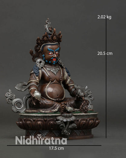 Side view of Dzambhala wealth deity statue showing intricate ornaments sacred iconography