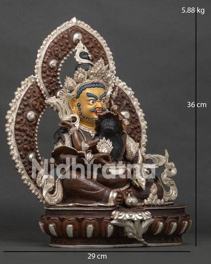 Side view of Dzambhala with consort handcrafted by Newari artisans in Nepal