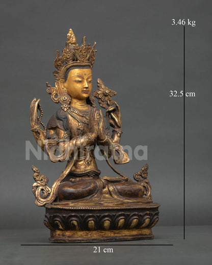 Side view of four armed Chenrezig Buddhist statue with antique copper finish and lotus seat