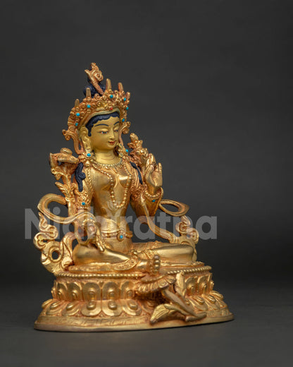 Side view of gold fire gilded Green Tara statue with blessing gesture and extended leg.