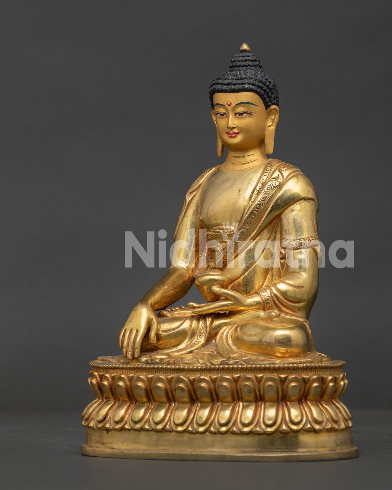 Side view of gold fire gilded Shakyamuni Buddha statue on double lotus throne.