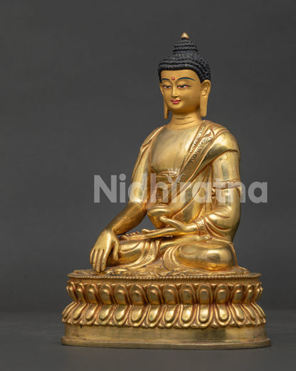 Side view of gold fire gilded Shakyamuni Buddha statue on double lotus throne.