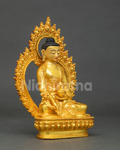 side view of gold gilded bhaisajyaguru statue with ornate carved radiant halo