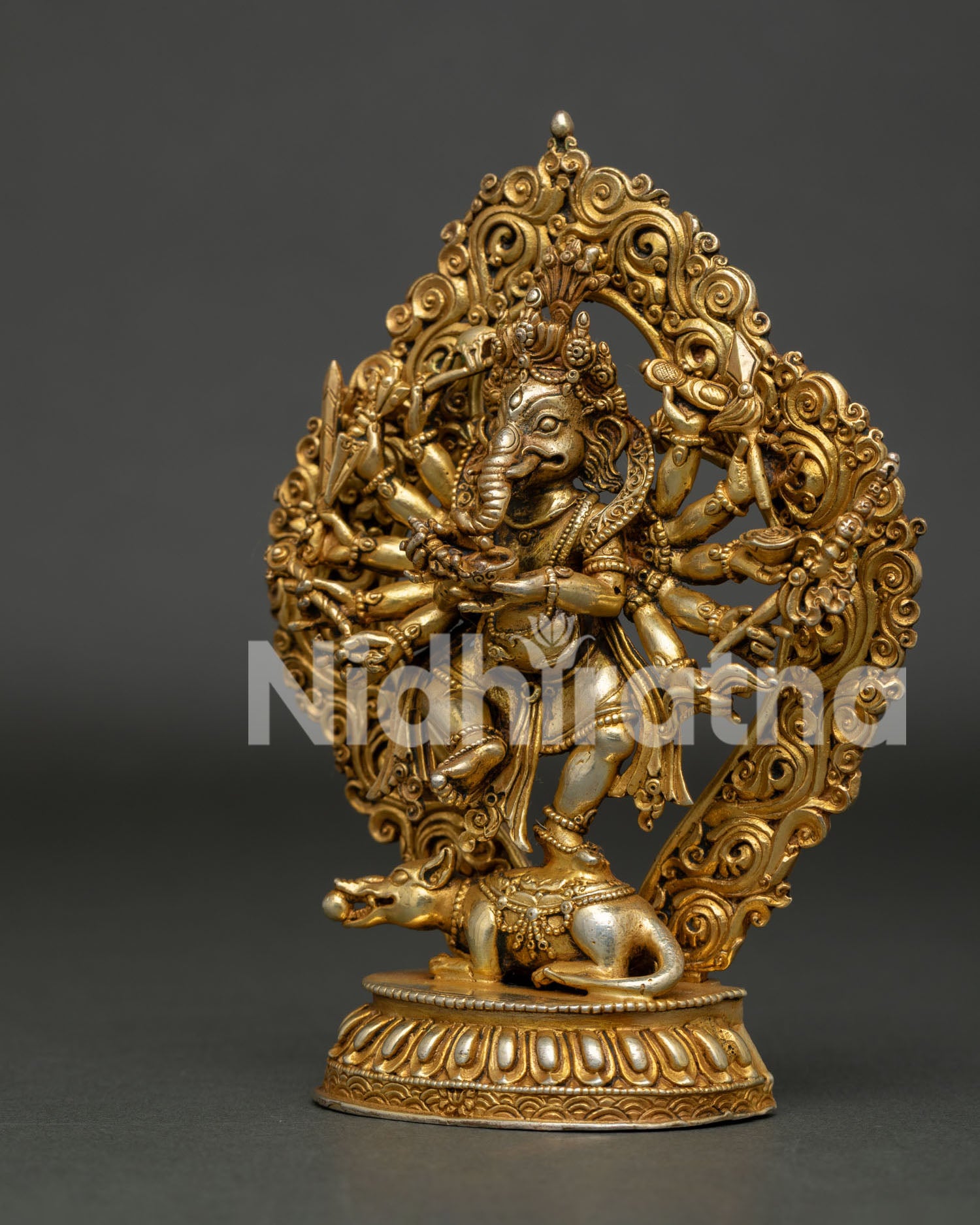 Side View of Gold Gilded Lord Ganesh Statue with Lotus Pedestal and Halo.