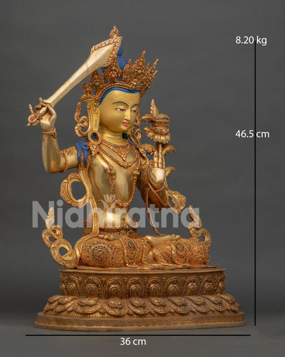 side view of gold gilded manjushri buddhist statue with intricate carvings