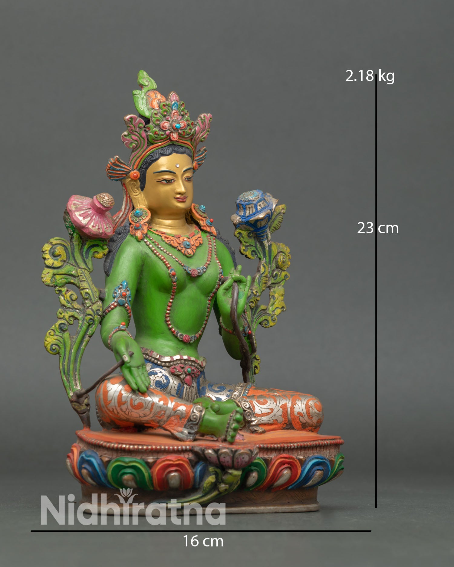 Side view of Green Tara Buddhist goddess statue seated on lotus throne with right foot extended and hand in varada mudra symbolizing compassion and protection
