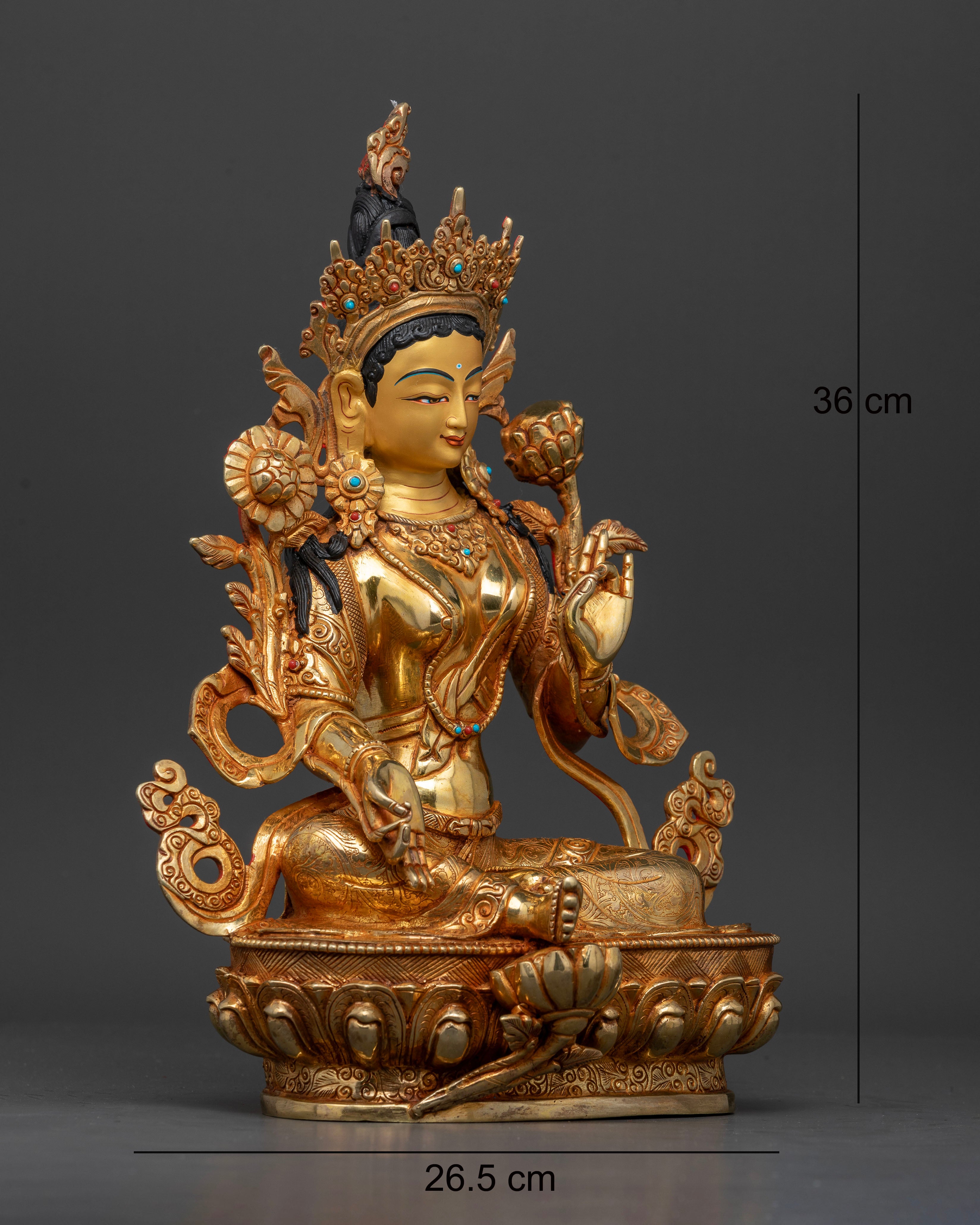 Side view of Green Tara Buddhist statue holding Utpala flower in Varada Mudra