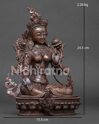 Side view of Green Tara Buddhist statue in Lalitasana posture with lotus flower