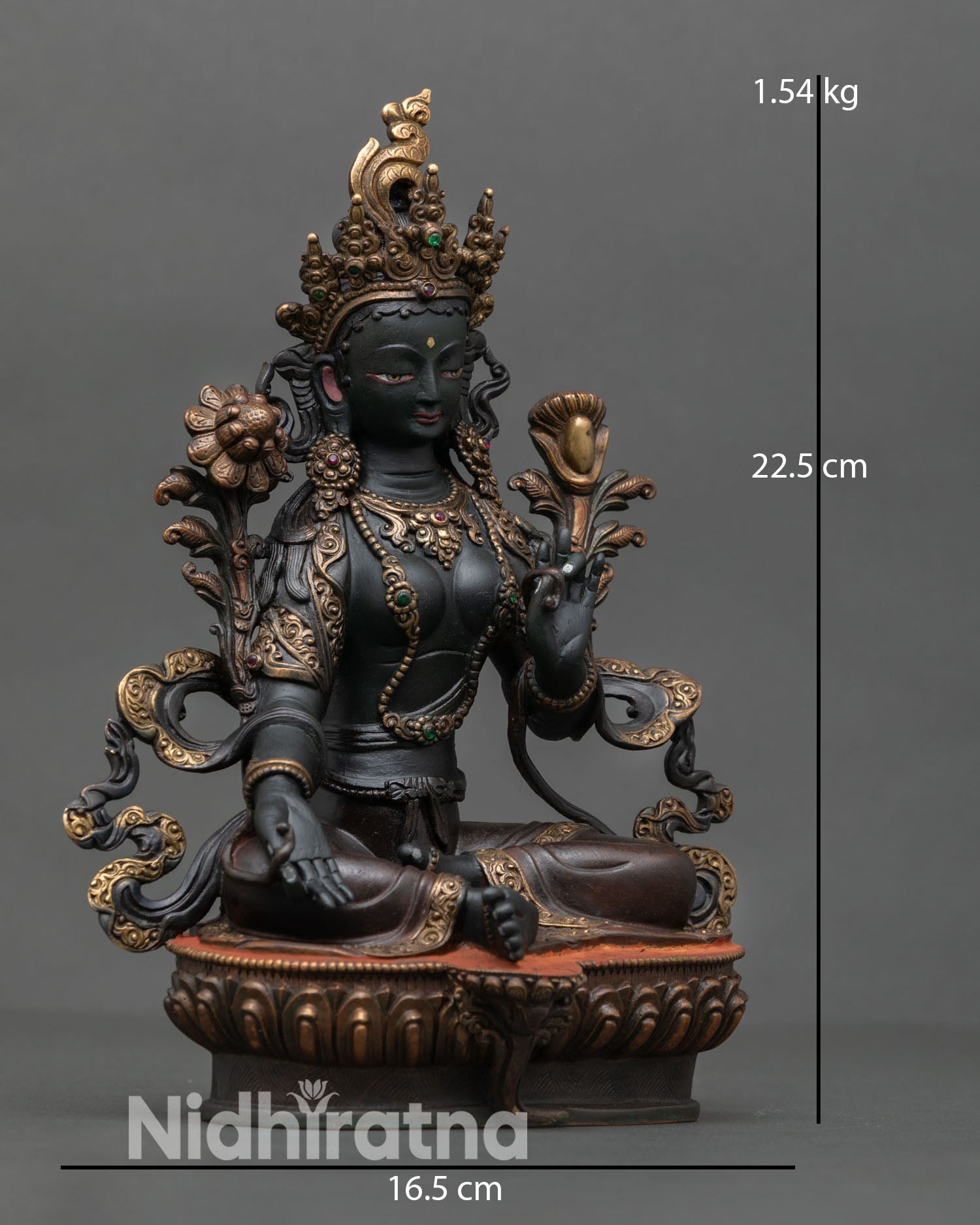 Side view of Green Tara statue depicting graceful posture lotus flower seat and Utpala flower symbol of compassion and liberation.