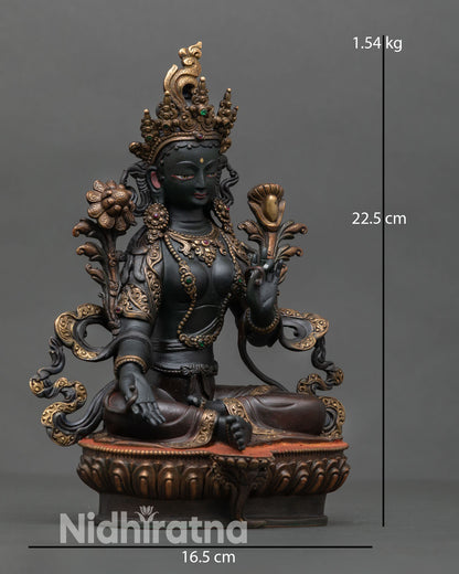 Side view of Green Tara statue depicting graceful posture lotus flower seat and Utpala flower symbol of compassion and liberation.