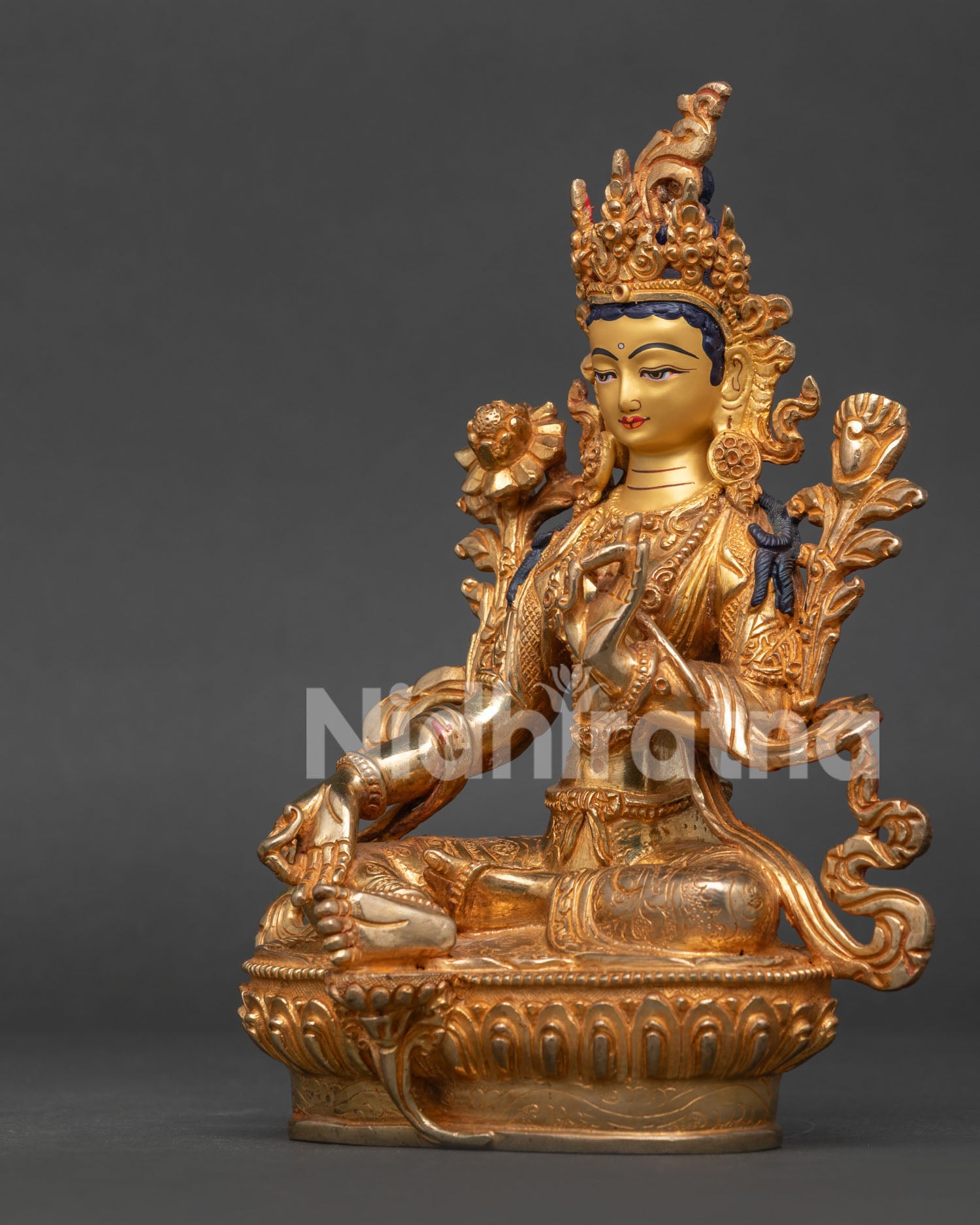 Side View of Green Tara Statue Extended Leg and Blooming Lotus Pedestal.