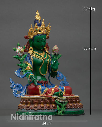 Side view of Green Tara statue revealing flowing adornments lotus seat and sacred Utpala flower held in hand.