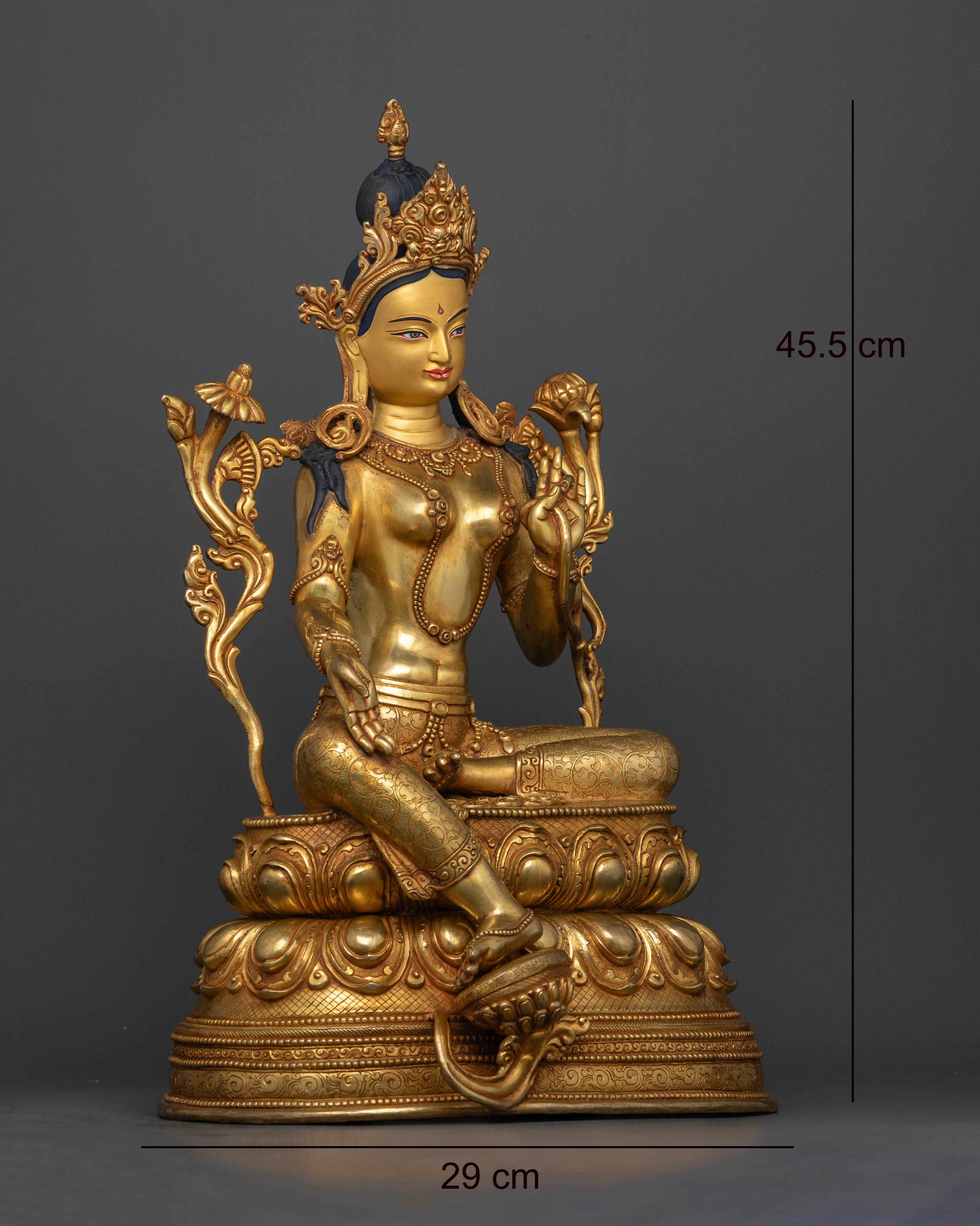 Side view of Green Tara statue seated in Lalitasana posture on lotus pedestal