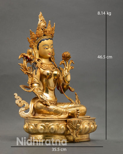 Side view of Green Tara statue seated on lotus throne with hand gesture of compassion, Buddhist art from Nepal