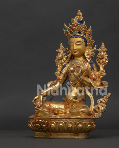 Side View of Green Tara Statue with Right Leg Extended on Lotus Throne.