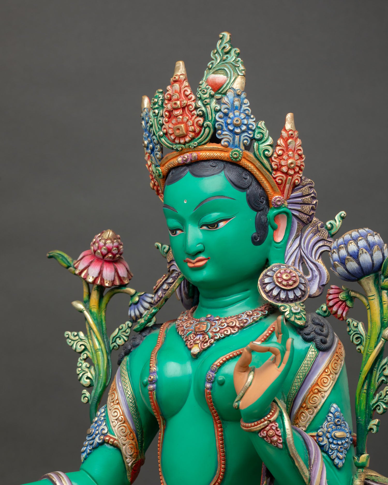 Side view of Green Tara statue with royal ease posture