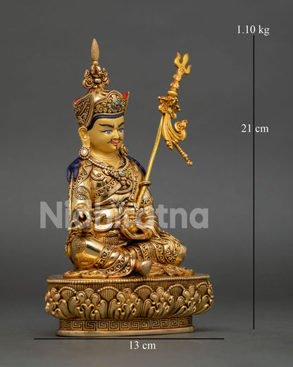 Side view of Guru Rinpoche Padmasambhava statue showing intricate ornaments, semi-precious stones, vajra, kalash, and khatvanga.