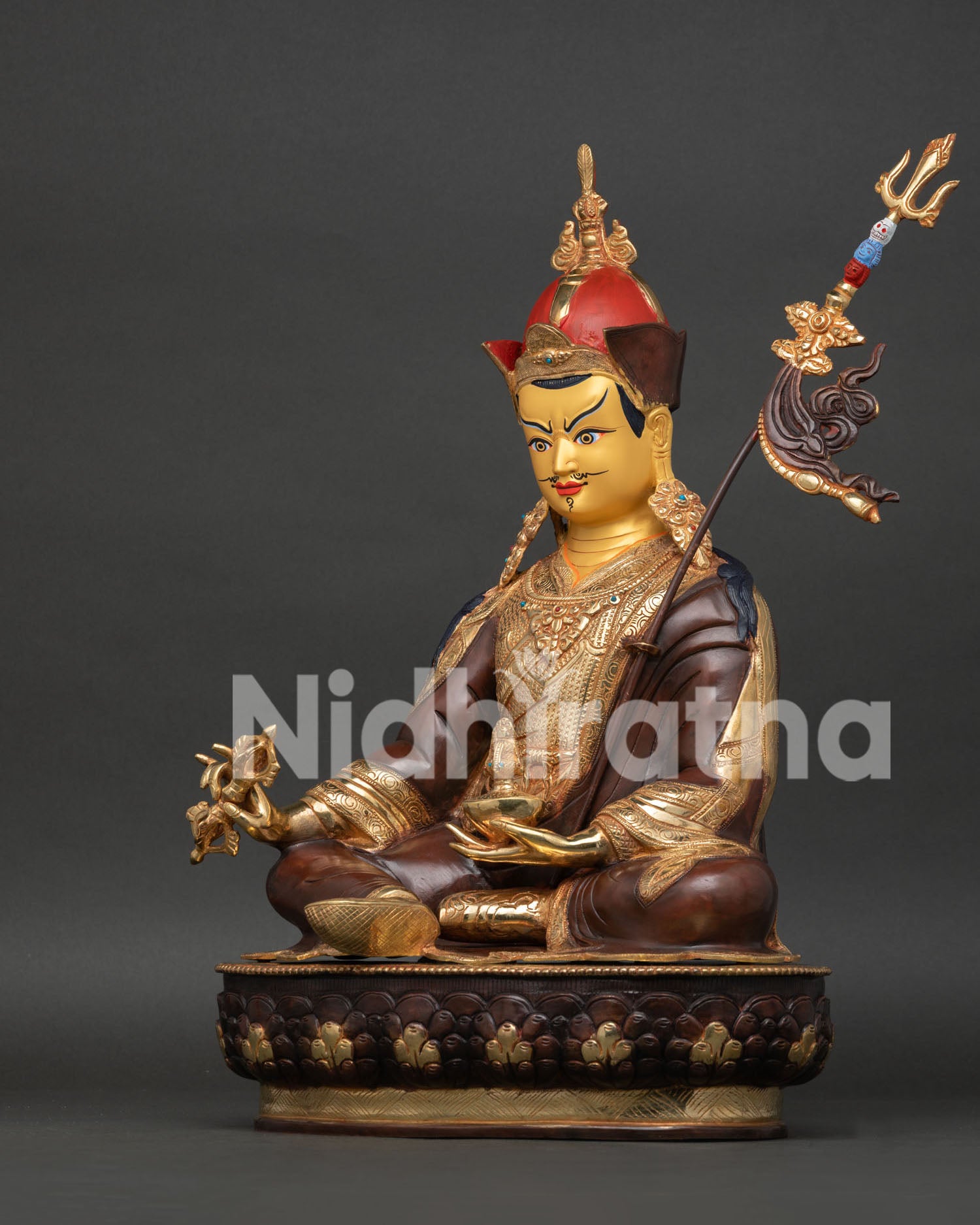 Side view of Guru Rinpoche Statue displaying vajra, skull cup, khatvanga staff, and craftsmanship.