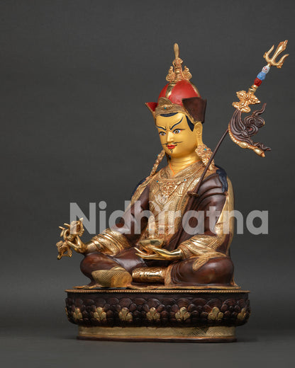 Side view of Guru Rinpoche Statue displaying vajra, skull cup, khatvanga staff, and craftsmanship.
