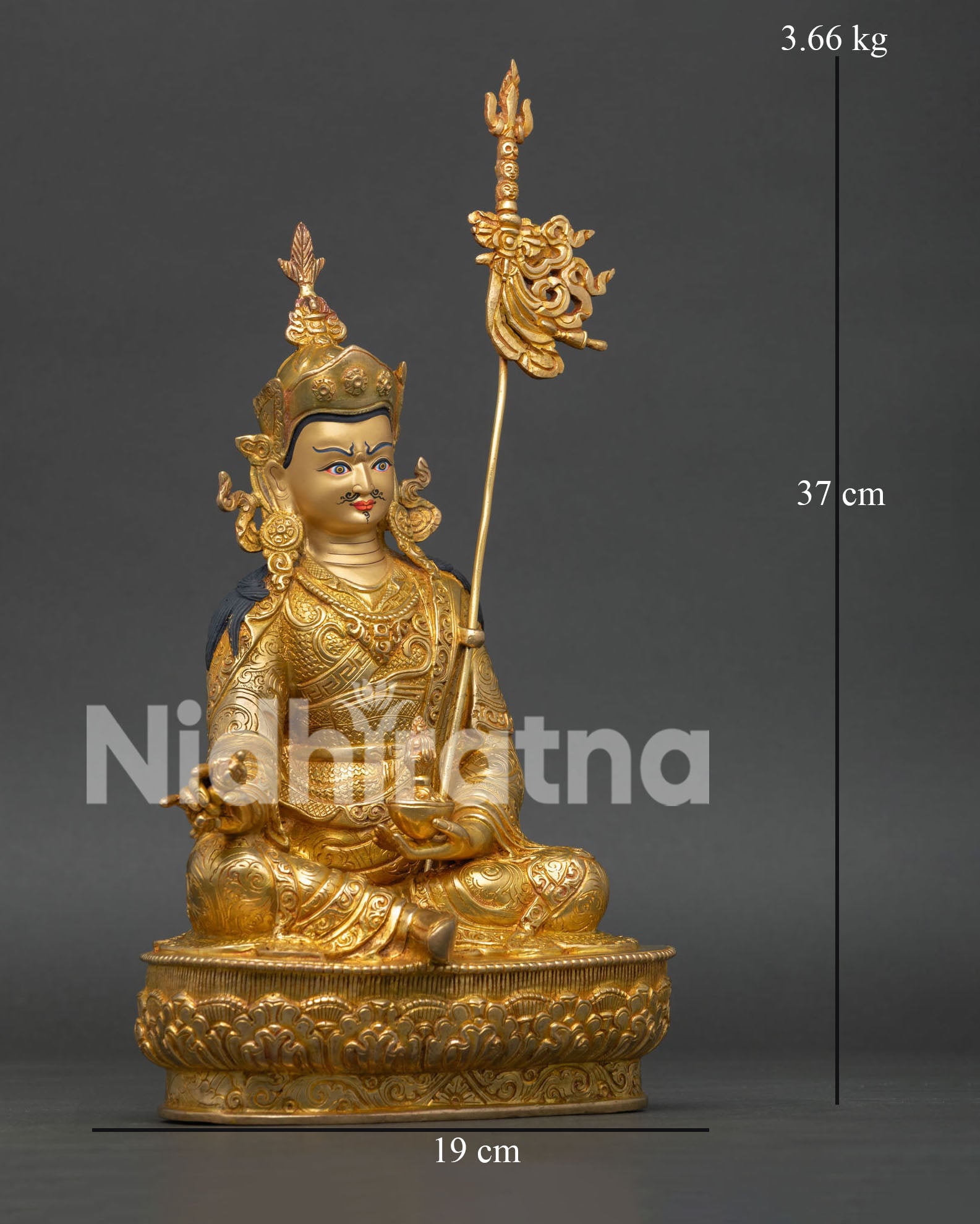 Side View of Guru Rinpoche Statue Holding Vajra and Skull Cup with Sacred Khatvanga Staff