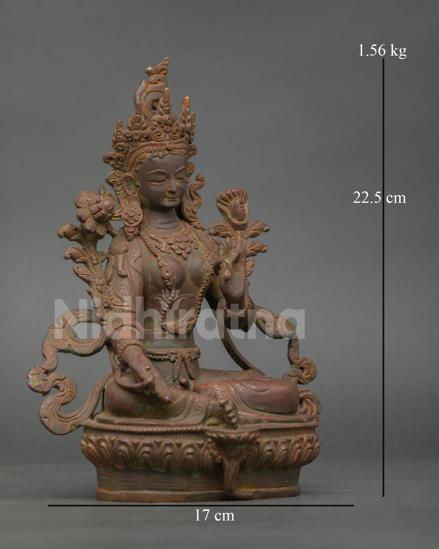 Side view of handcrafted green tara statue with lotus seat and traditional nepalese buddhist art