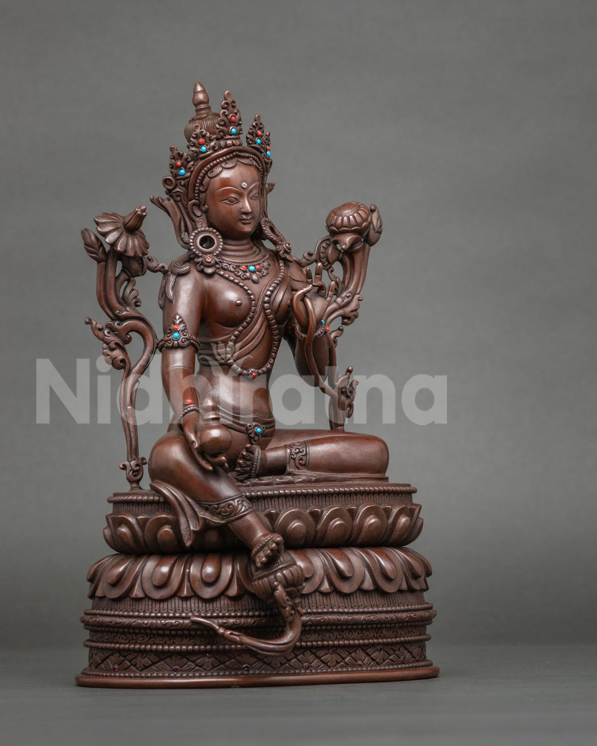 Side view of handcrafted Tibetan Green Tara statue in royal ease posture