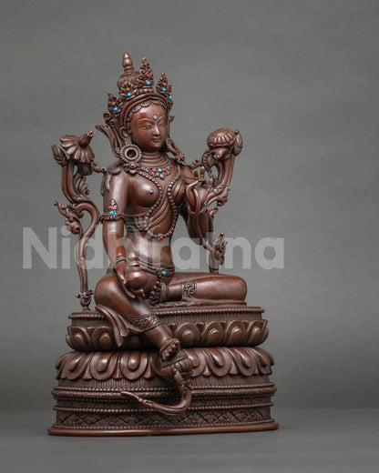 Side view of handcrafted Tibetan Green Tara statue in royal ease posture
