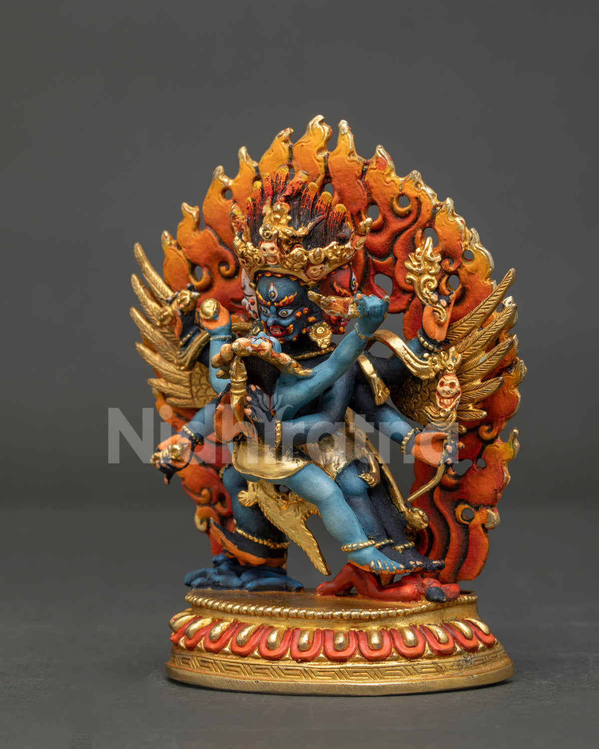 Side view of handcrafted Vajrakilaya Dorje Phurba statue showing gold-gilded wings and flame halo