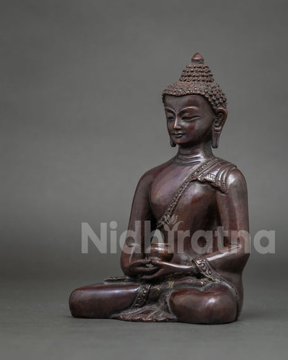 Side view of handmade Amitabha Buddha statue showing seated meditation pose and copper patina
