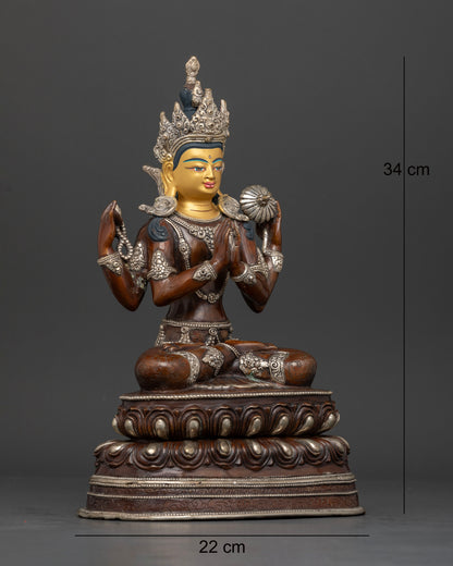 Side view of Himalayan Chenrezig statue holding sacred mala and lotus flower artwork