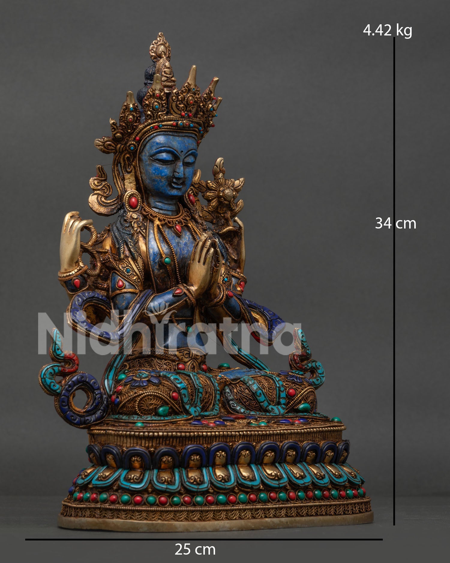 Side view of Himalayan Chenrezig statue seated on double lotus pedestal with sacred symbols
