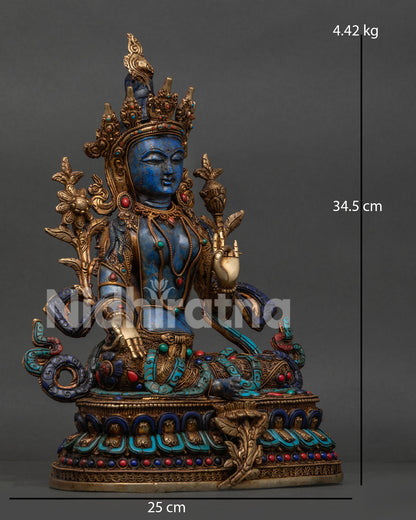 Side view of Himalayan Green Tara statue on double lotus pedestal with extended right leg