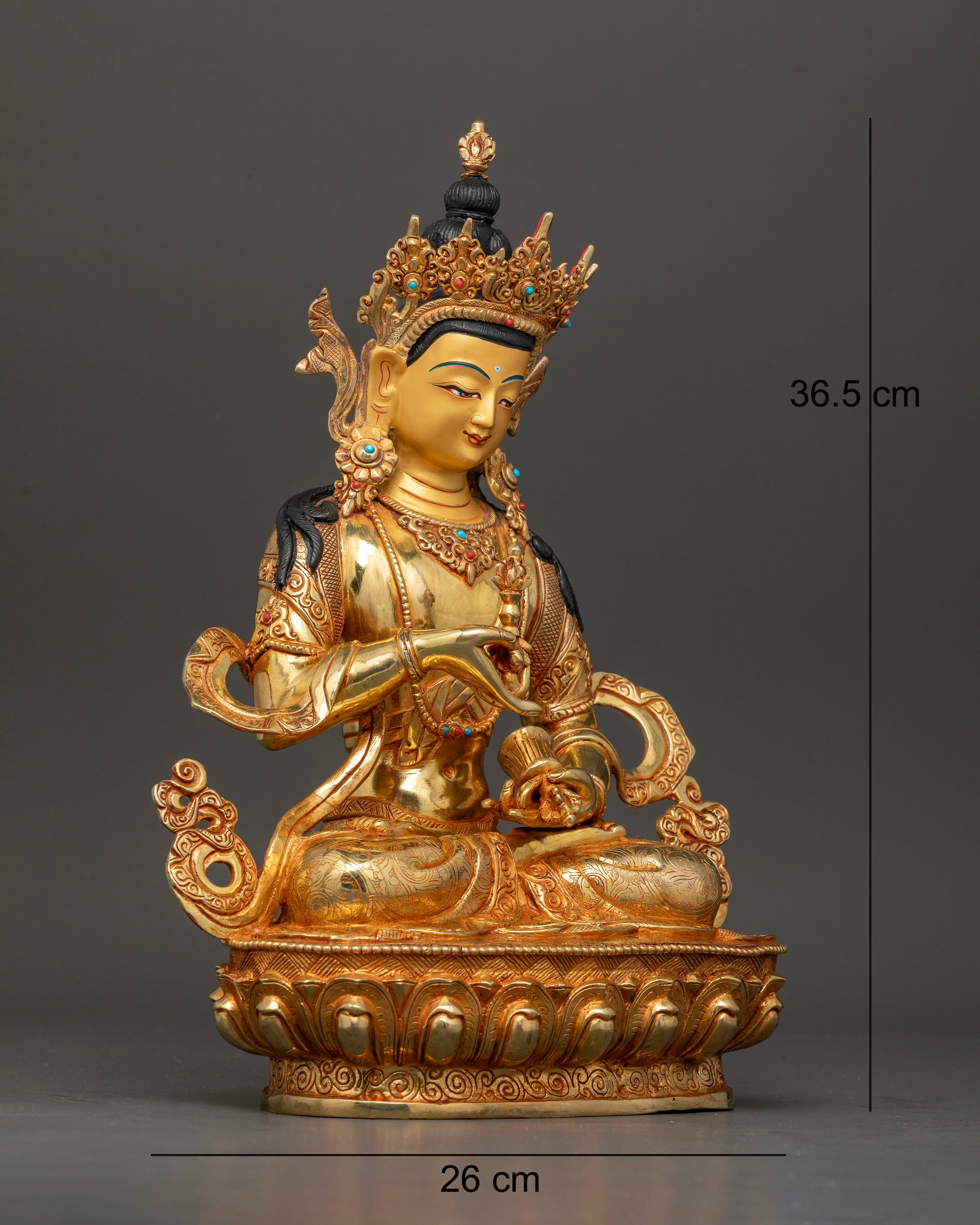 Side view of Himalayan Vajrasattva statue seated on lotus pedestal with sacred symbols